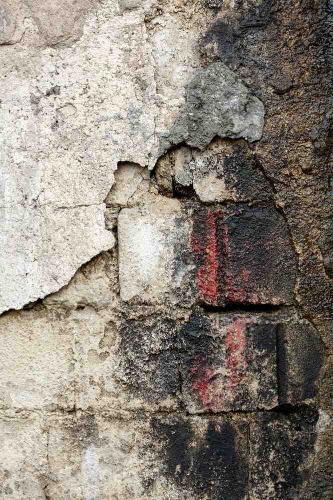 Fire and soot damaged brick wall requiring restoration.