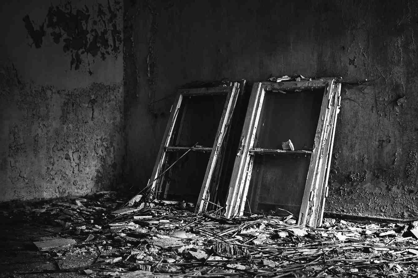 Interior property damage showing ruined walls and structural debris requiring professional cleanup and restoration.