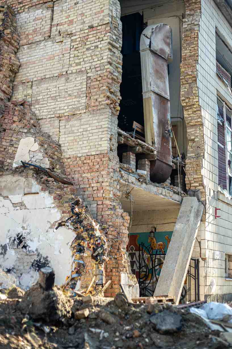 Severe structural fire damage exposing the interior of a collapsed brick building.