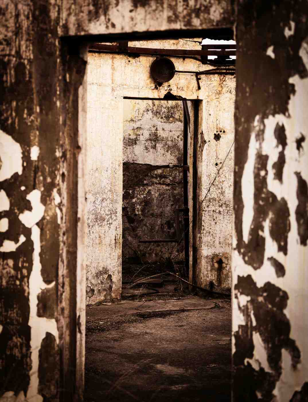 Looking through a doorway at severe interior smoke damage and soot-stained walls needing professional fire cleanup.