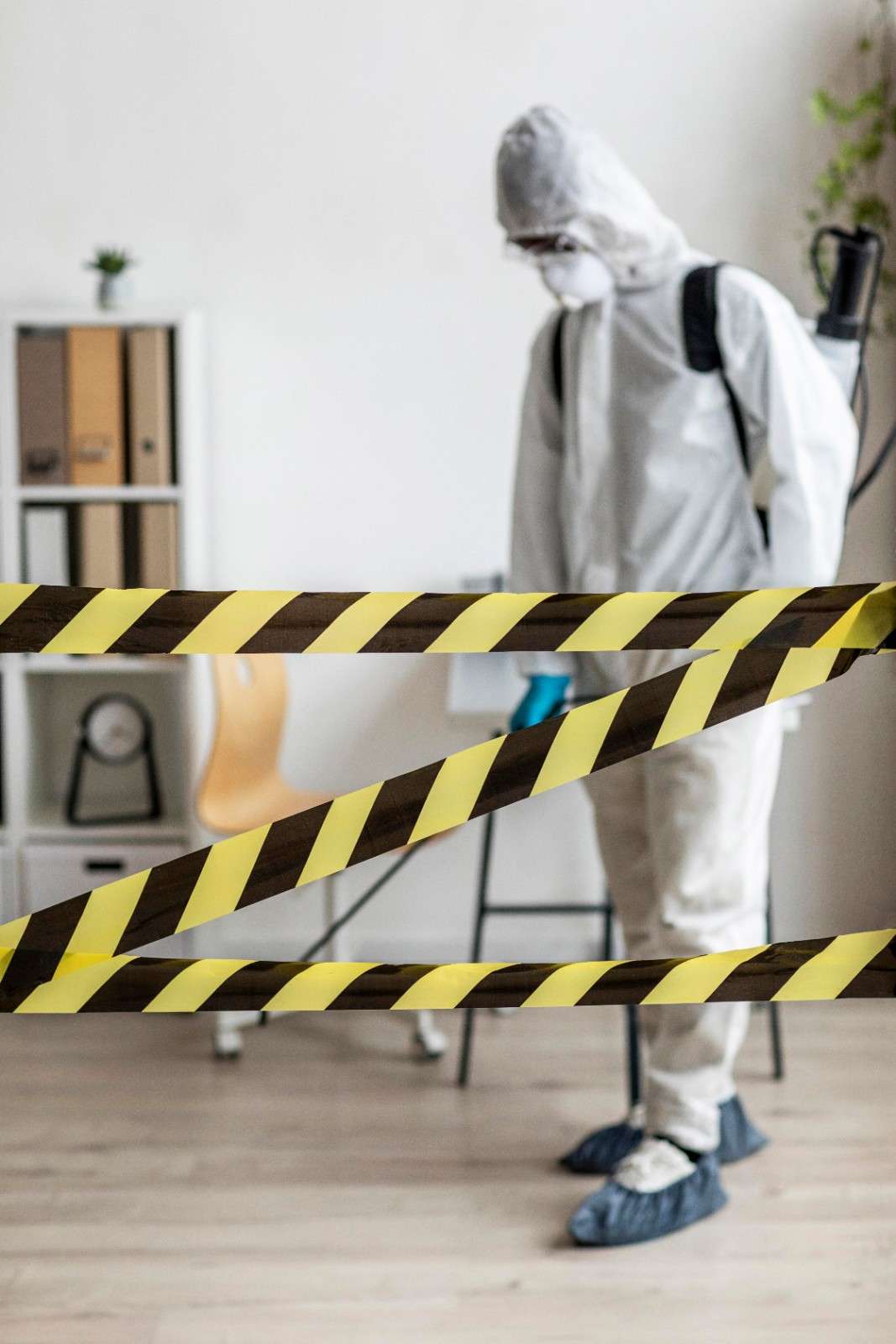 Certified mold remediation technician wearing protective gear during residential mold removal and cleanup.