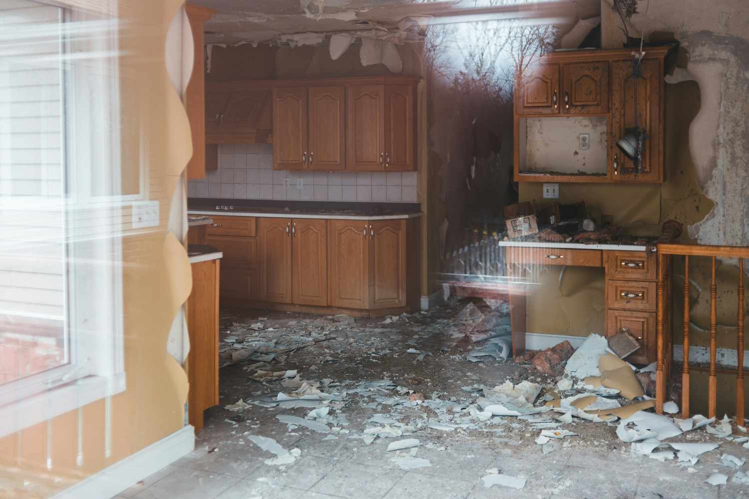 Severe indoor water damage in an Upper Marlboro kitchen with collapsed ceiling and debris.