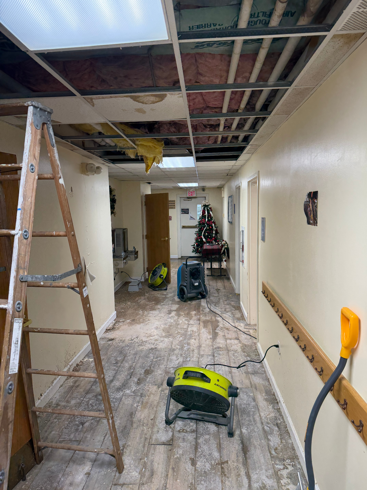 Hallway drying with air movers after ceiling water damage