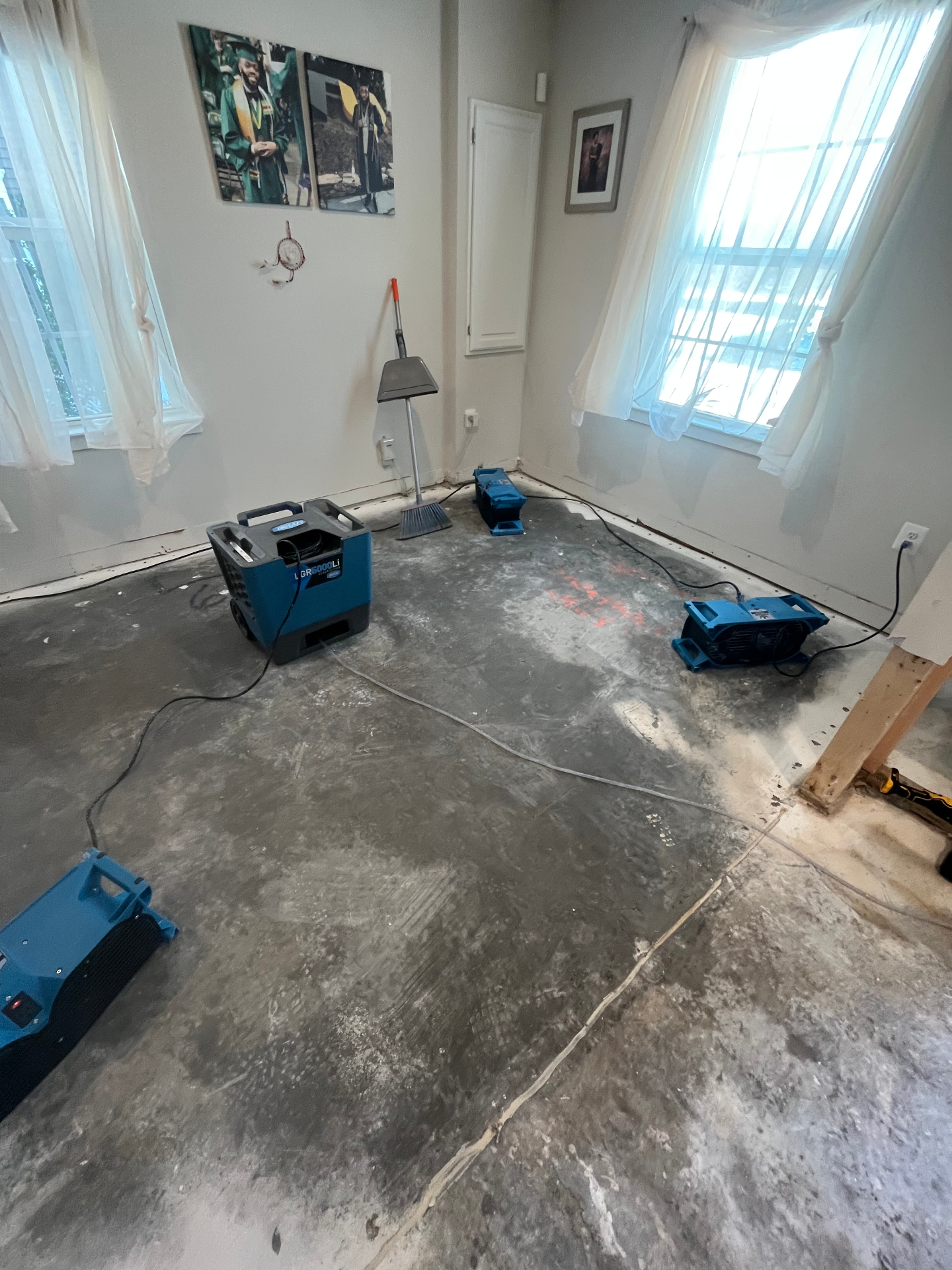 Room drying with dehumidifiers and air movers after water damage