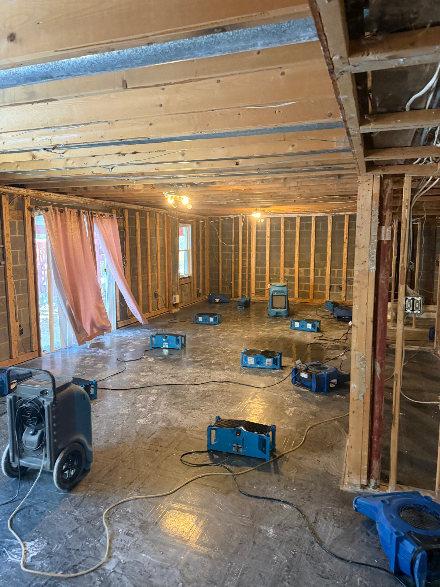 Basement drying with multiple air movers and dehumidifier